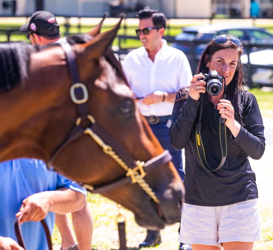 Katherine Wheeler takes pictures of Hip #206 on Tuesday during the Ocala Breeders' Sales Company's 2022 Spring Sale of Two-Year-Olds in Training.