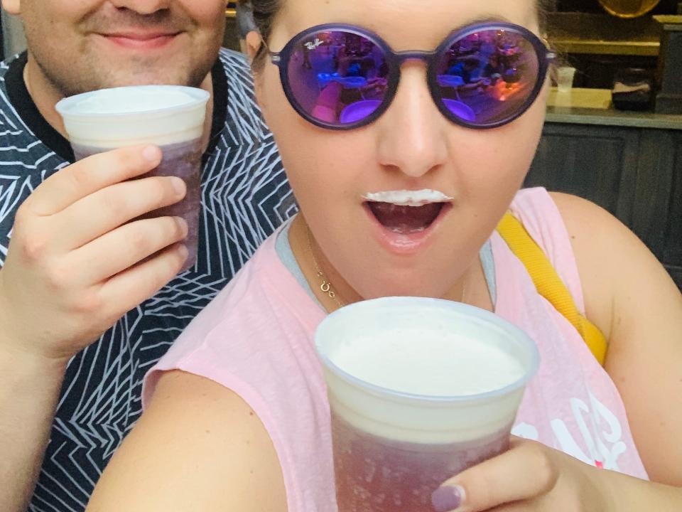 Carly Caramanna and her husband drinking butterbeer at universal studios orlando