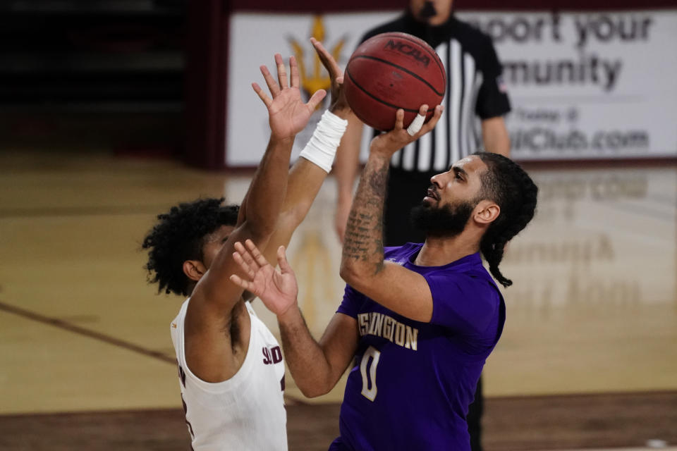 Washington guard Marcus Tsohonis (0) shoots over Arizona State guard Remy Martin during the second half of an NCAA college basketball game, Thursday, Feb. 25, 2021, in Tempe, Ariz. (AP Photo/Rick Scuteri)