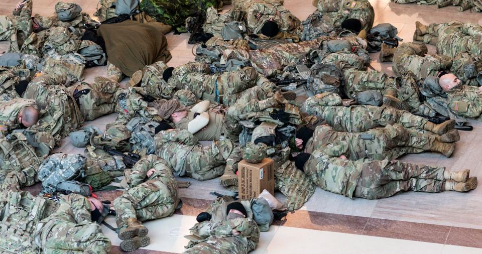 <p>National Guard troops sleep on the floor of the Capitol Visitor Center on Wednesday, Jan. 13, 2021, as security ramps up in advance of the Inauguration.</p>