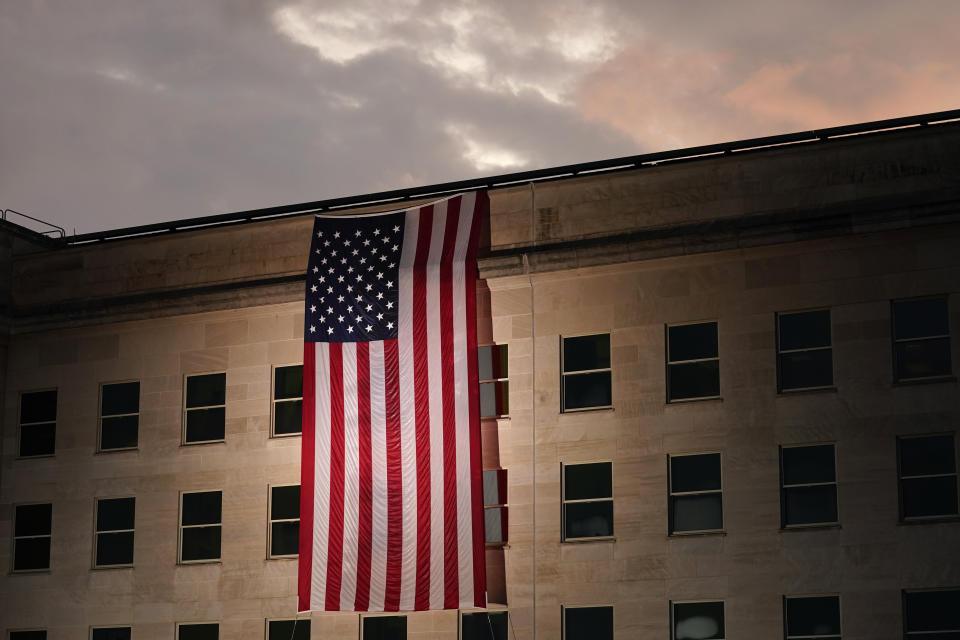 A large American flag is unfurled at the Pentagon ahead of ceremonies at the National 9/11 Pentagon Memorial to honor the 184 people killed in the 2001 terrorist attack on the Pentagon, in Washington, Friday Sept. 11, 2020. (AP Photo/J. Scott Applewhite)