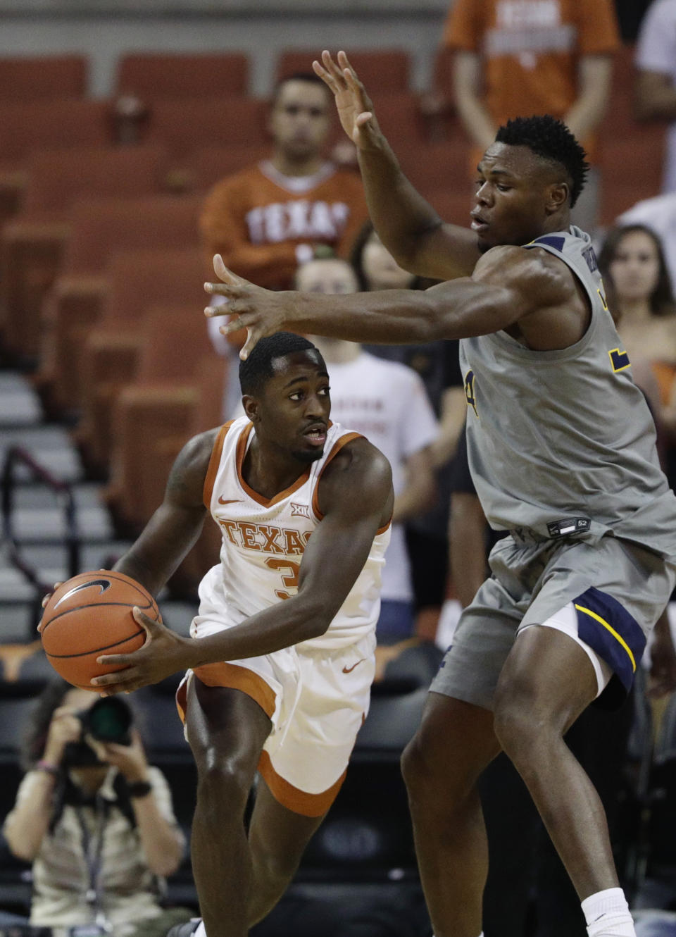 Texas guard Courtney Ramey (3) is pressured by West Virginia forward Oscar Tshiebwe (34) during the first half of an NCAA college basketball game, Monday, Feb. 24, 2020, in Austin, Texas. (AP Photo/Eric Gay)