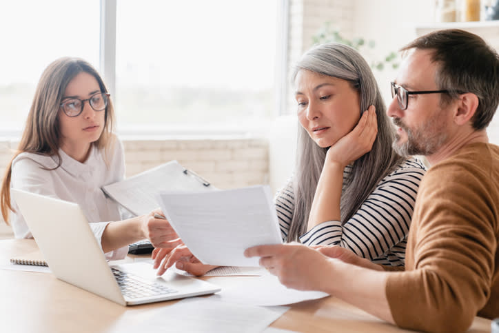 A couple meets with a financial advisor to review late payment options for their taxes.