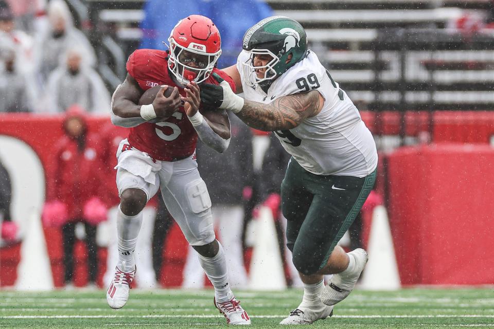 Rutgers Scarlet Knights running back Kyle Monangai fights for yards against Michigan State Spartans defensive lineman Jalen Sami during the second half at SHI Stadium on October 14, 2023 in Piscataway, New Jersey.