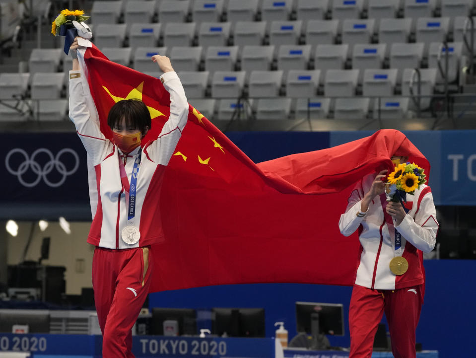 Chen Yuxi of China, left, silver medal and Quan Hongchan of China, gold medal react after winning gold medal in women's diving 10m platform final at the Tokyo Aquatics Centre at the 2020 Summer Olympics, Thursday, Aug. 5, 2021, in Tokyo, Japan. (AP Photo/Dmitri Lovetsky)