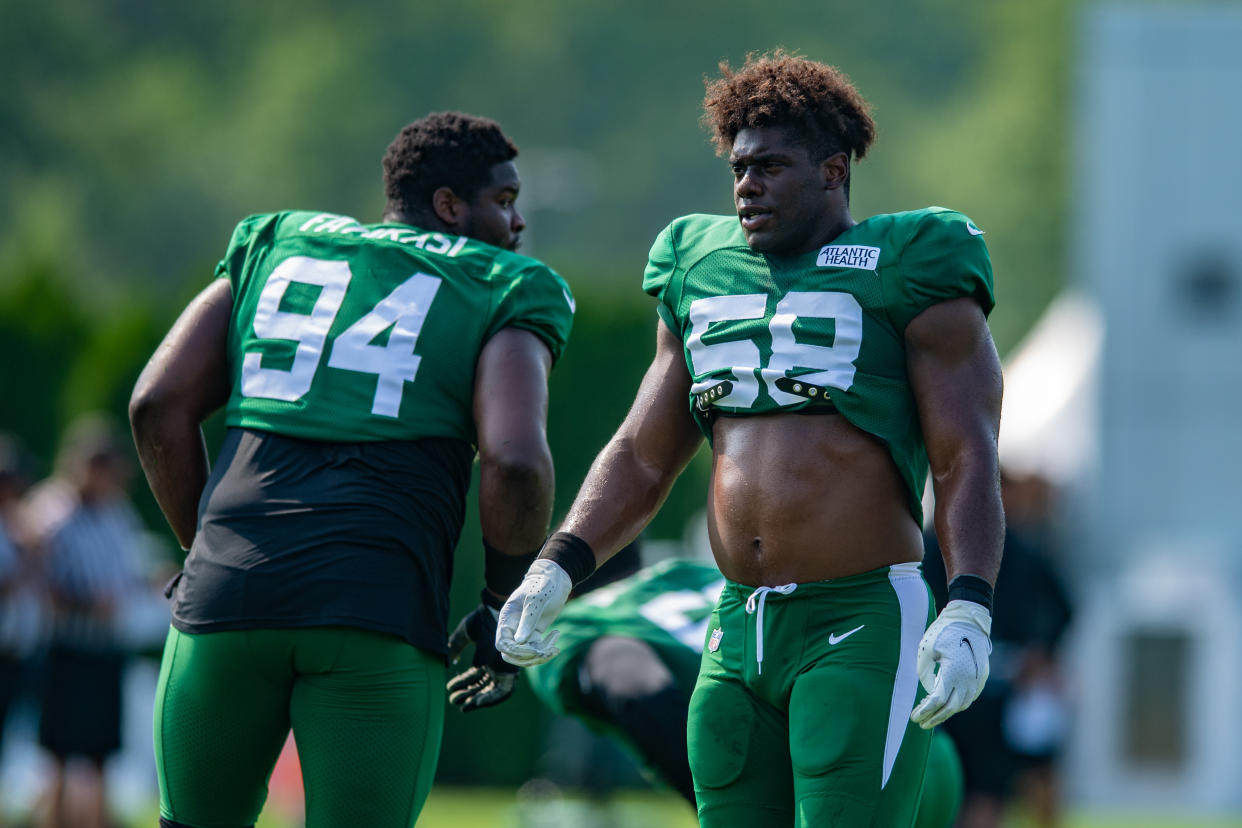 Carl Lawson (right) will miss the 2021 NFL season with an Achilles injury. (Photo by John Jones/Icon Sportswire via Getty Images)