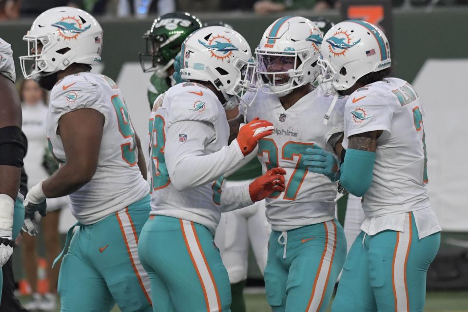 Dolphins running back Myles Gaskin, right, celebrates his touchdown during last Sunday's win over the Jets. The running game could be a key for Miami Sunday against the Carolina Panthers, who lead the NFL in pass defense.