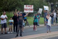 <p>A protester stands by the motorcade transporting President Donald Trump to a briefing on Tropical Storm Harvey relief efforts at the Texas Department of Public Safety Emergency Operations Center in Austin, Texas, Aug. 29, 2017. (Photo: Carlos Barria/Reuters) </p>