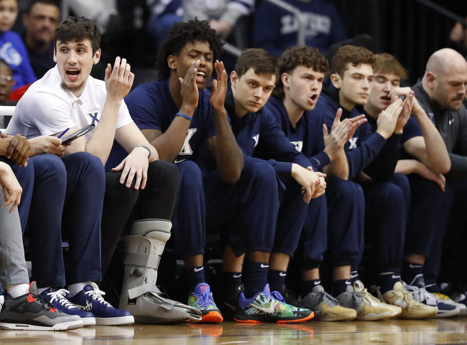 Xavier forward Zach Freemantle, left, and teammates watch play against Seton Hall during the first half of an NCAA college basketball game in Newark, N.J., Friday, Feb. 24, 2023. (AP Photo/Noah K. Murray)