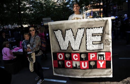 Occupy Wall Street demonstrators gather prior to a march to join teacher's unions near Wall Steet in New York. Thousands of anti-corporate demonstrators backed for the first time in large numbers by trade unions poured into New York's financial district Wednesday, raising the stakes in a more than two-weeks long street revolt