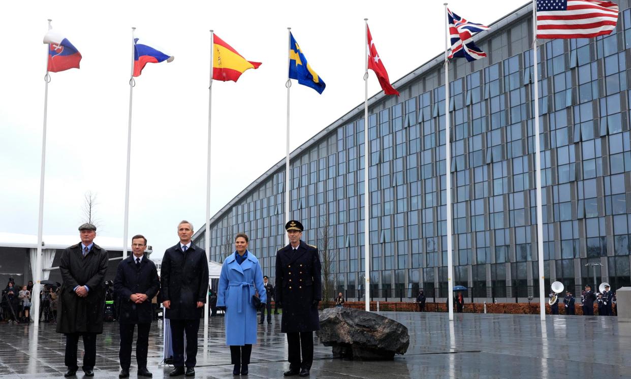 <span>Sweden’s prime minister, Ulf Kristersson (second left) and Crown Princess Victoria mark the country’s accession to Nato in March 2024.</span><span>Photograph: Geert Vanden Wijngaert/AP</span>