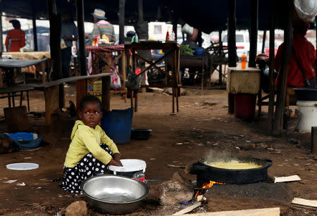 A child sits amongst vendors stalls in Mbare township, Harare, Zimbabwe, January 23, 2019. REUTERS/Philimon Bulawayo