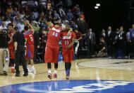 Dayton's Devon Scott (40) and Scoochie Smith (11) celebrate after the second half in a regional semifinal game against Stanford at the NCAA college basketball tournament, Thursday, March 27, 2014, in Memphis, Tenn. Dayton won 82-72. (AP Photo/John Bazemore)