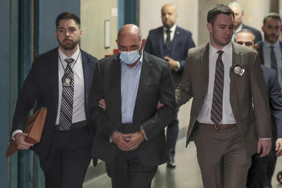 Allen Weisselberg, center, is escorted to Manhattan criminal court, Monday, March 4, 2024, in New York. Weisselberg, the former chief financial officer of the Trump Organization, surrendered to the Manhattan district attorney Monday morning for arraignment on new criminal charges, the prosecutor's office said. (AP Photo/Yuki Iwamura)