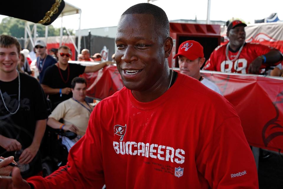 TAMPA - JULY 31:  Head coach Raheem Morris of the Tampa Bay Buccaneers signs some autographs during training camp at One Buccaneer Place on July 31, 2010 in Tampa, Florida.  (Photo by J. Meric/Getty Images)