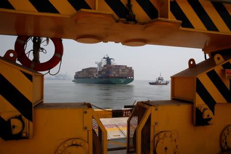 A container ship is seen through the base of a crane as it leaves the New Priok Container Terminal One (NPTC1) in Tanjung Priok, North Jakarta, Indonesia, May 26, 2017. REUTERS/Darren Whiteside