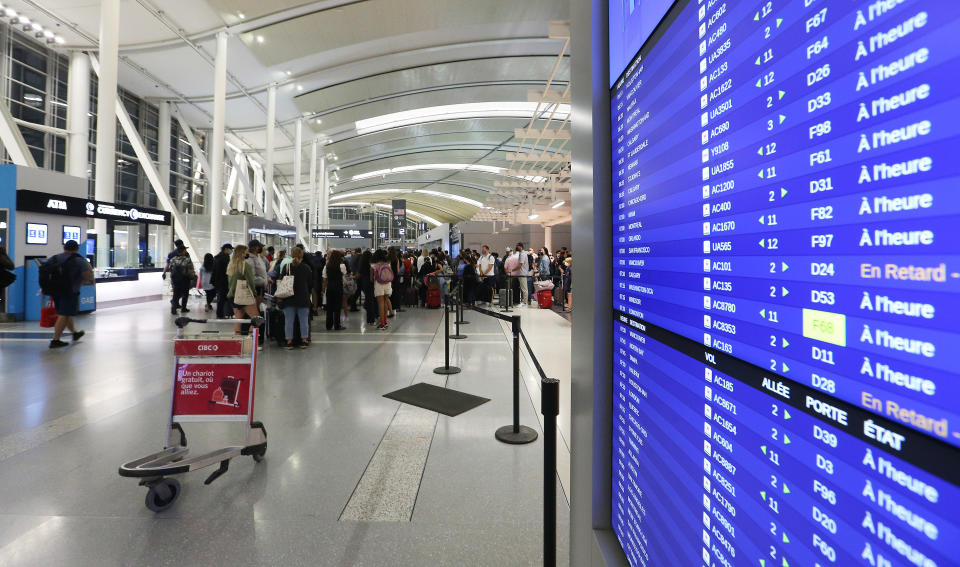 TORONTO, ON - JULY 22  - Passengers line up waiting at Gates F.  Passengers in Toronto Pearson International Airport Terminal One early in the morning, passengers that arrive early are instructed to wait at pillars 14 and 15 for their flights to be called before they go to Gate F for security and customs.  in Toronto. July 22, 2022.        (Steve Russell/Toronto Star via Getty Images)