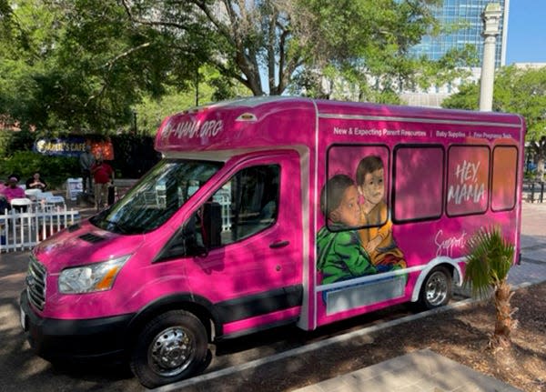 The Northeast Florida Healthy Start Coalition's new "Hey, Mama Mobile Pantry" is adorned with illustrations of babies and a family.