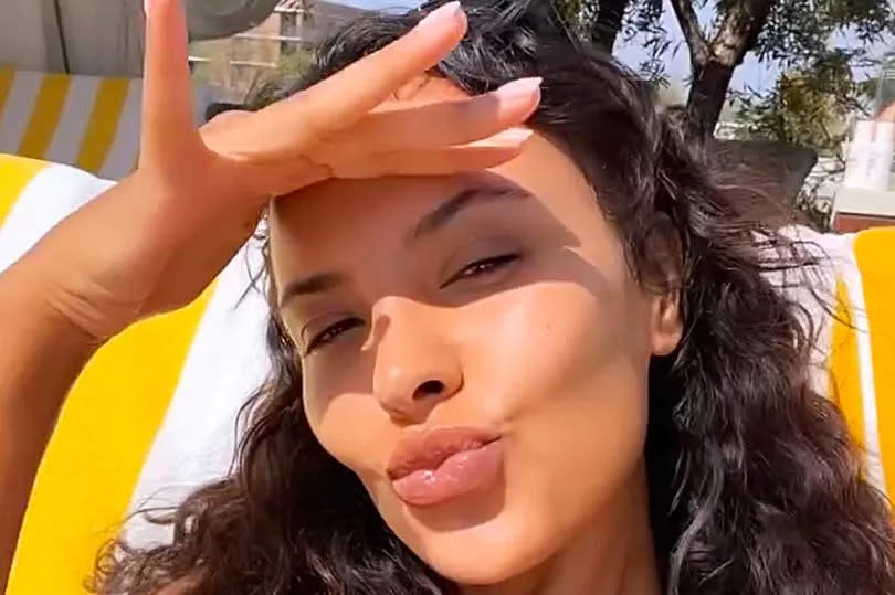 Maya Jama sunbathes in a black bikini