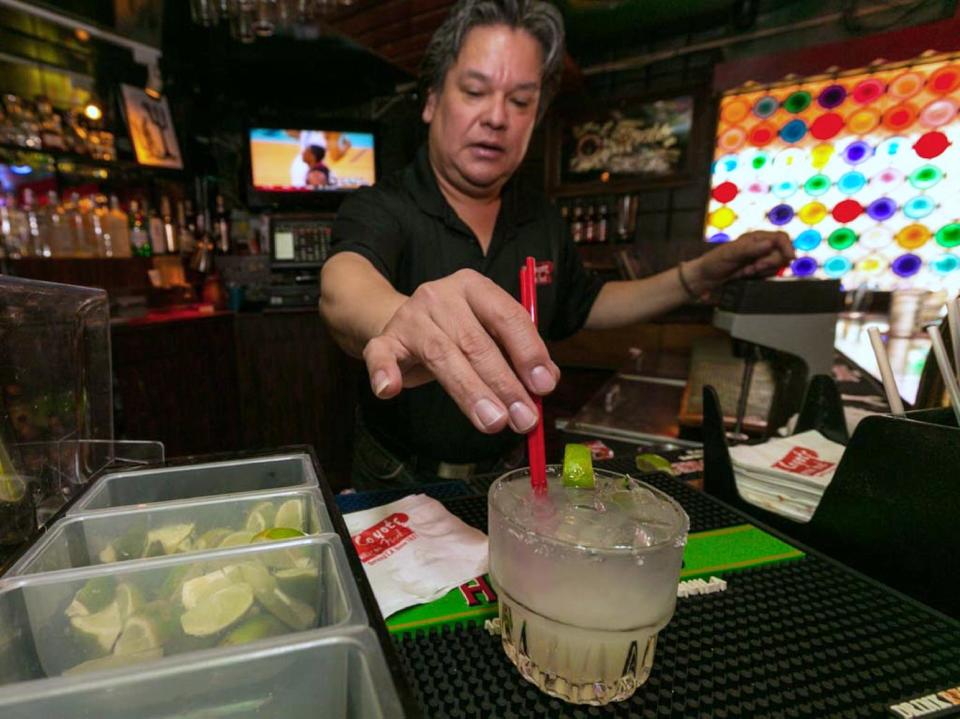 In this Monday, April 28, 2014 photo, barman Mario Sanchez mixes a margarita cocktail at the bar of El Coyote, a Mexican restaurant in Los Angeles. Thousands of restaurateurs from coast to coast who have fallen victim to the Great Green Citrus Crisis of 2014. The lime has skyrocketed in price in recent weeks, quadrupling or, in some areas, going even higher. (AP Photo)