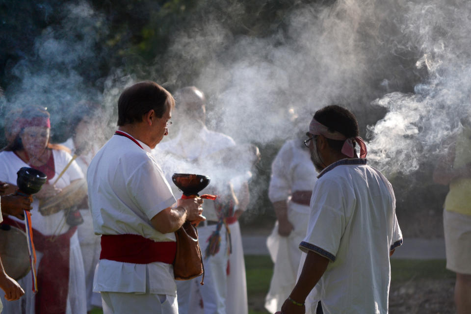 In this July 22, 2012 photo provided by the University of New Mexico, participants of a University of New Mexico workshop on curanderismo, or traditional Mexican folk healing, burn copal during a ceremony on campus. The Maxwell Museum of Anthropology in Albuquerque, N.M. is scheduled to host an exhibit this summer on curanderismo and will invite healers from Latin America to give talks on a traditional healing field that is growing in the United States thanks to immigration from Latin America. (AP Photo/Courtesy of the University of New Mexico)