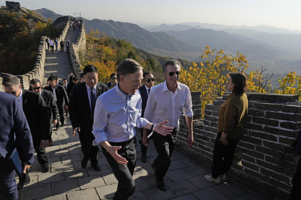 U.S. ambassador to China Nicholas Burns, center left, chats with California Gov. Gavin Newsom as they visit the Mutianyu Great Wall on the outskirts of Beijing, Thursday, Oct. 26, 2023. Newsom is on a weeklong tour of China where he is pushing for climate cooperation. His trip as governor, once considered routine, is drawing attention as it comes after years of heightening tensions between the U.S. and China. (AP Photo/Ng Han Guan)