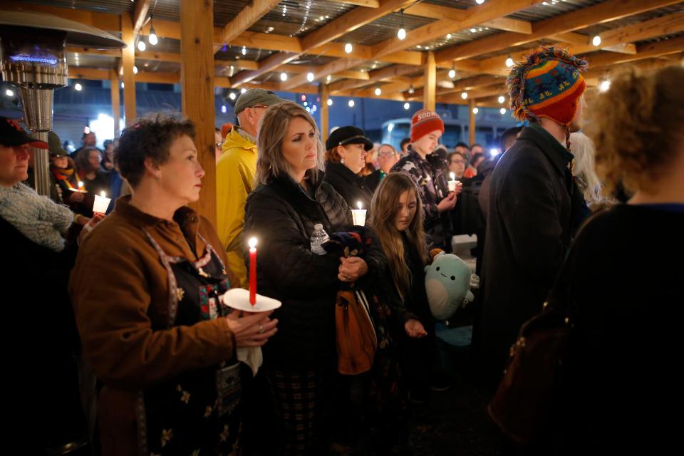 Community members listen during a candlelight vigil for Shannon Hanchett on Monday in Norman. Hanchett, a local bakery owner and longtime mental health advocate, died early Thursday at the Cleveland County jail.