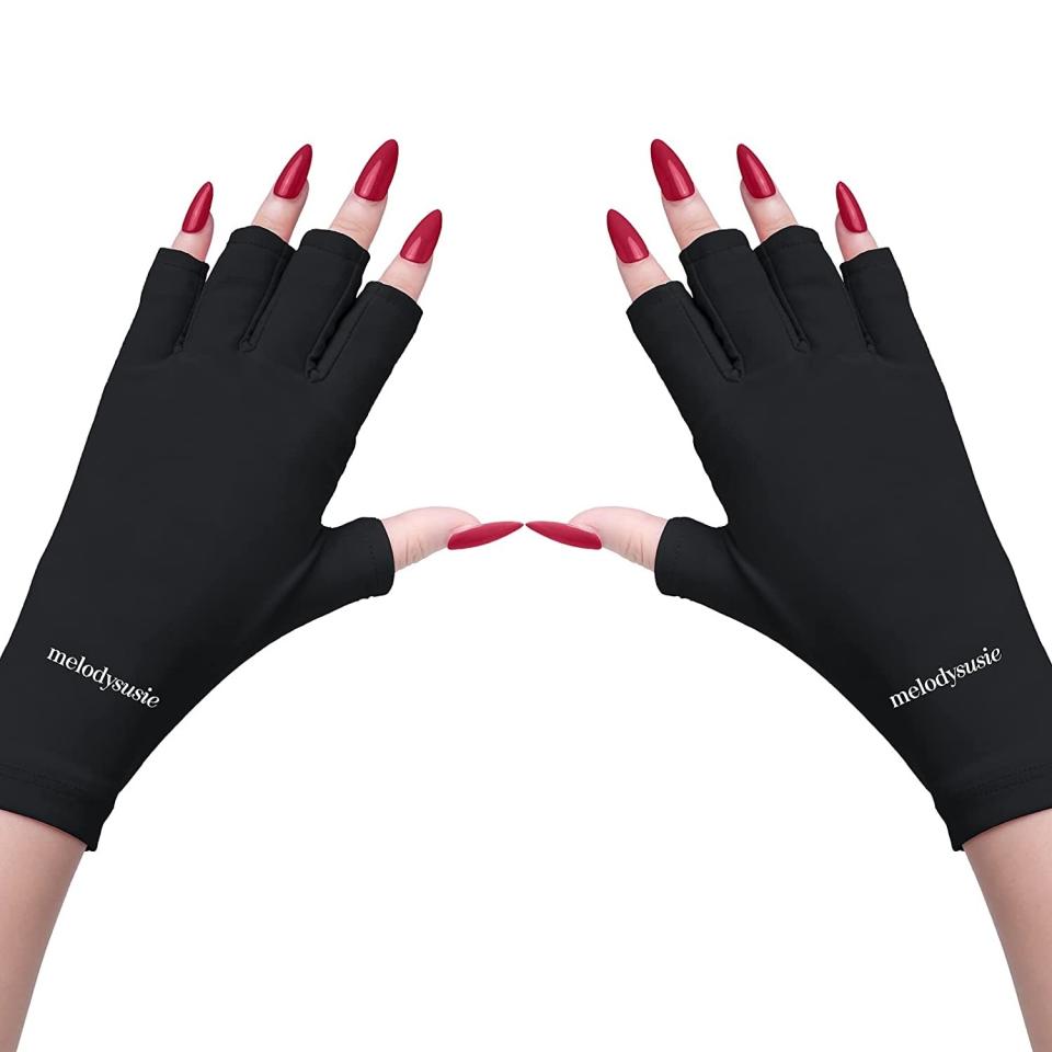 image of a woman wearing fingerless gloves to protect against UV rays from gel manicures