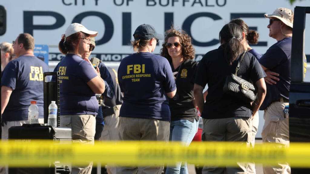 Police and FBI agents continue their investigation of the shooting at Tops market on May 15, 2022 in Buffalo, New York. (Photo by Scott Olson/Getty Images)