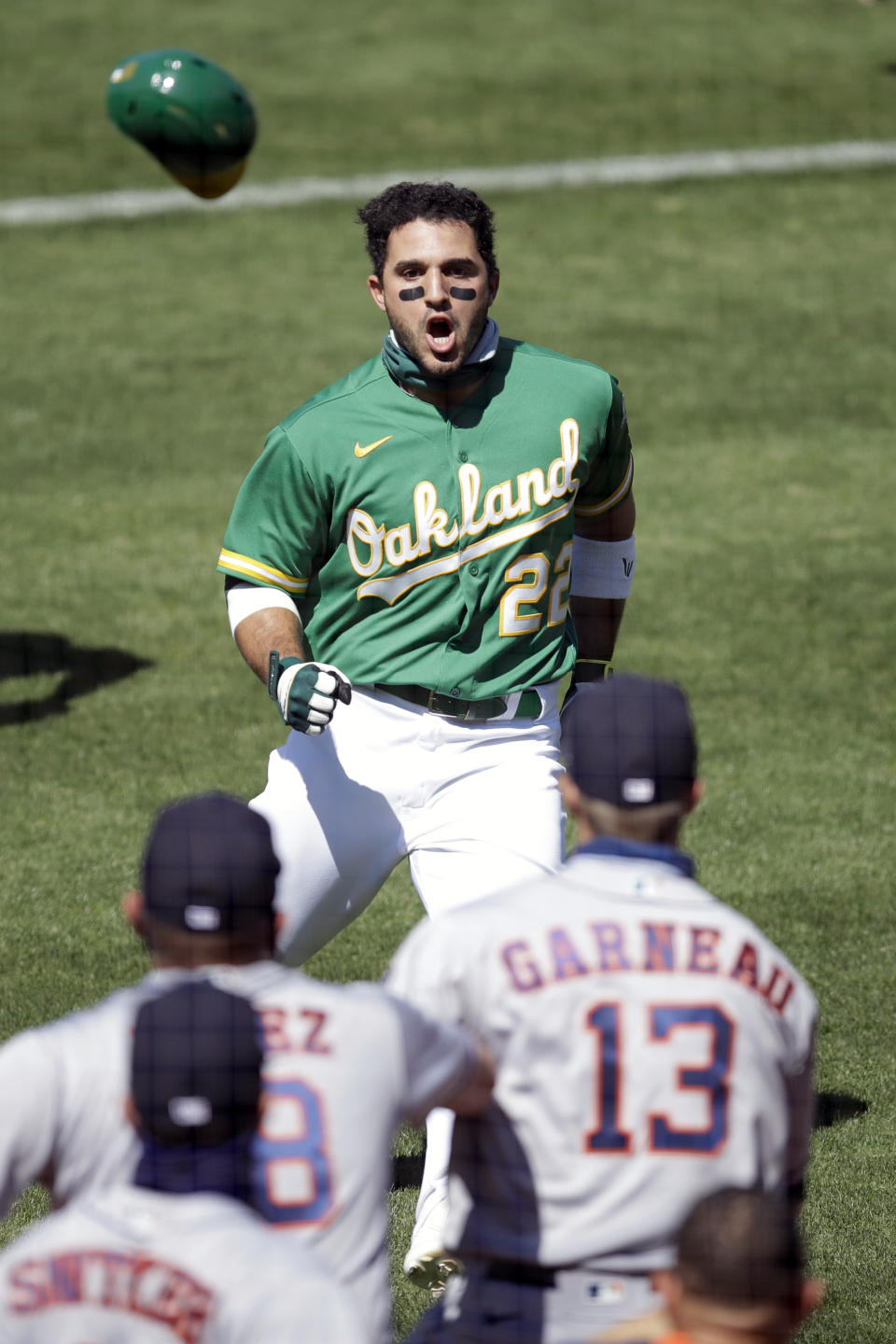 CORRECTS TO A PITCH THROWN BY ASTROS' HUMBERTO CASTELLANOS NOT ANDRE SCRUBB - Oakland Athletics' Ramon Laureano (22) charges the Houston Astros dugout after being hit by a pitch thrown by Astros' Humberto Castellanos in the seventh inning of a baseball game Sunday, Aug. 9, 2020, in Oakland, Calif. (AP Photo/Ben Margot)