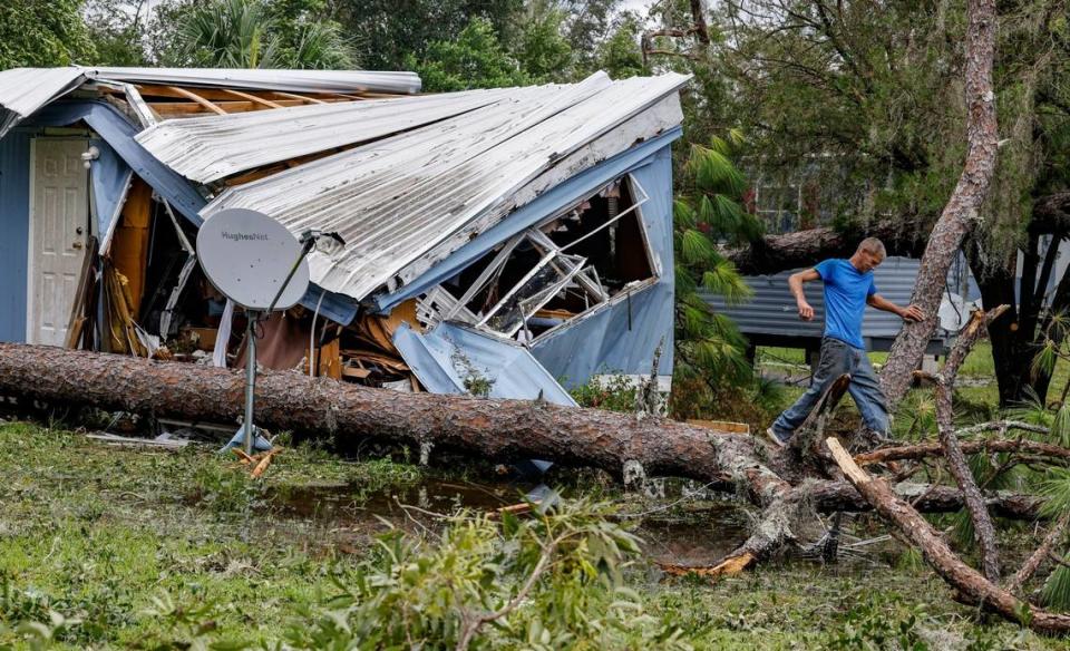 John McCranie, 50, steps over a fallen pine tree at Perry Cove Mobile Home and RV Park in Perry, Florida on Wednesday, August 30, 2023.