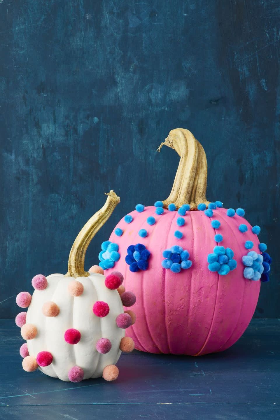 <p>Dress painted pumpkins up in colorful pom poms for a playful look that's perfect for a festive celebration with children in attendance. </p>