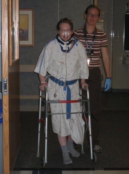 Piazza learning to walk again with the help of a physical therapist. (Photo: Courtesy of LiAnn Piazza)