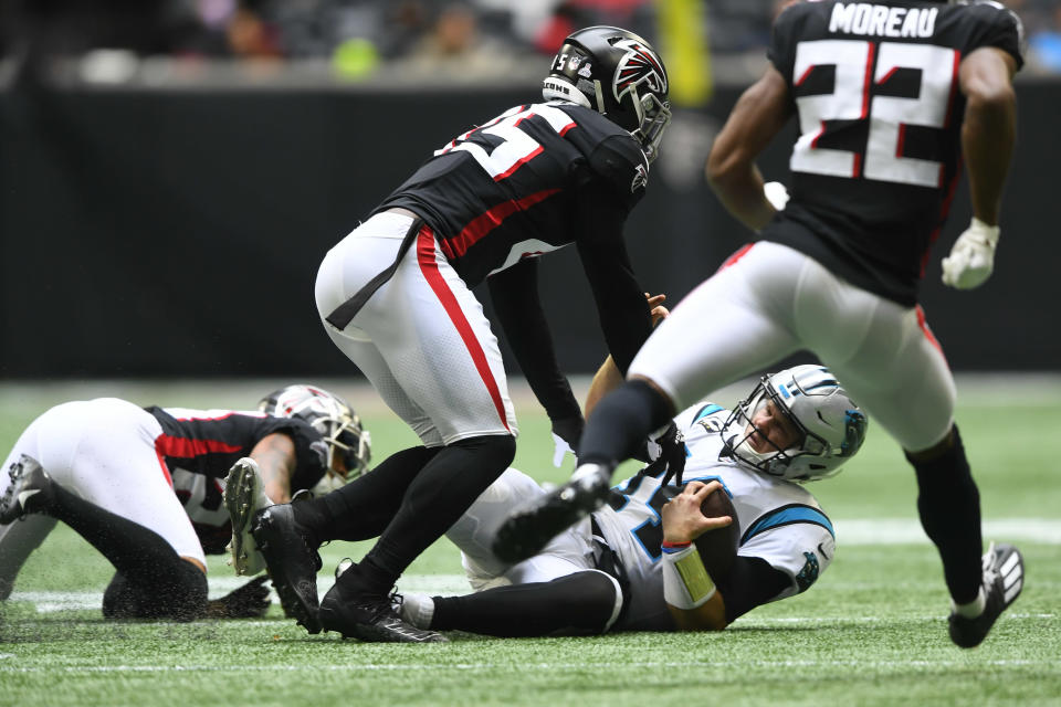 Carolina Panthers quarterback Sam Darnold (14) is sacked by Atlanta Falcons linebacker Deion Jones (45) during the first half of an NFL football game, Sunday, Oct. 31, 2021, in Atlanta. (AP Photo/John Amis)