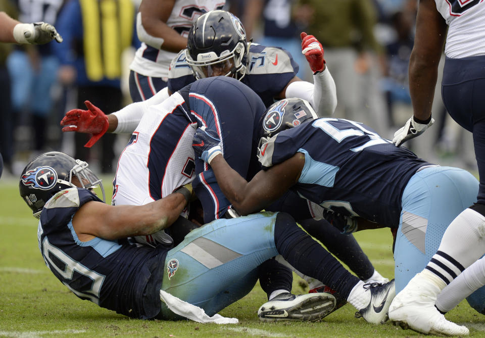 New England Patriots quarterback Tom Brady, center, is sacked by a group of Tennessee Titans defenders in the second half of an NFL football game Sunday, Nov. 11, 2018, in Nashville, Tenn. (AP Photo/Mark Zaleski)