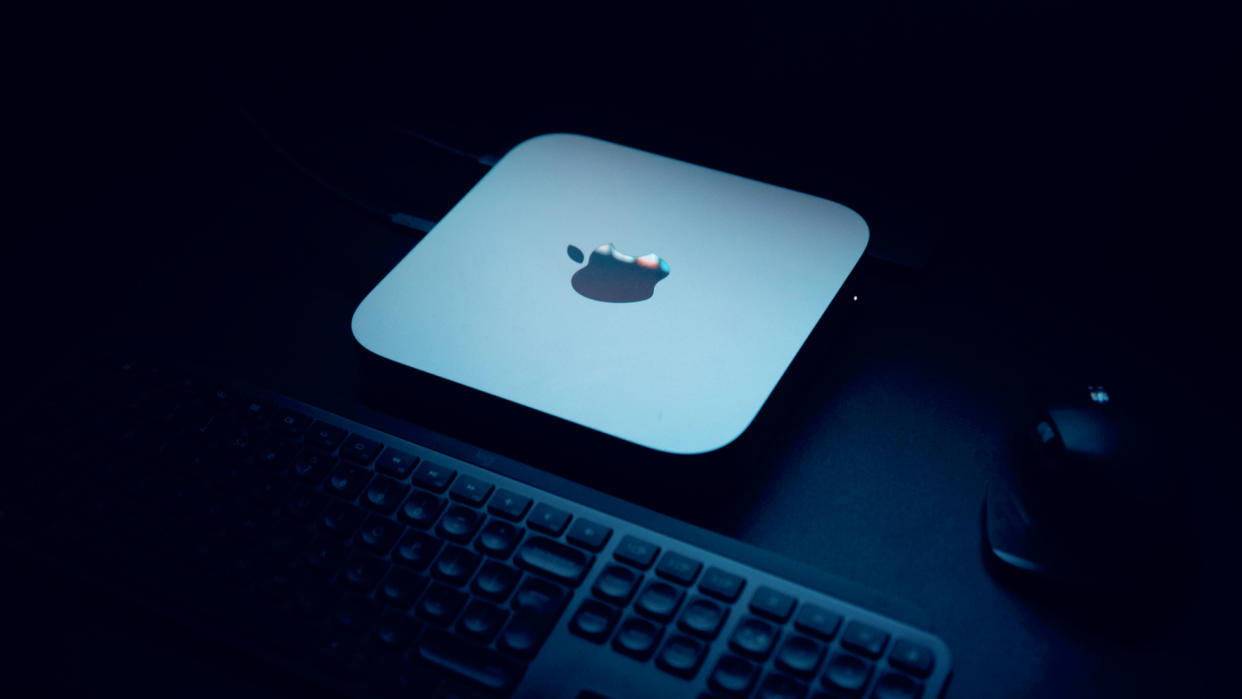  Apple Mac Mini M1 computer on a desk with keyboard. 