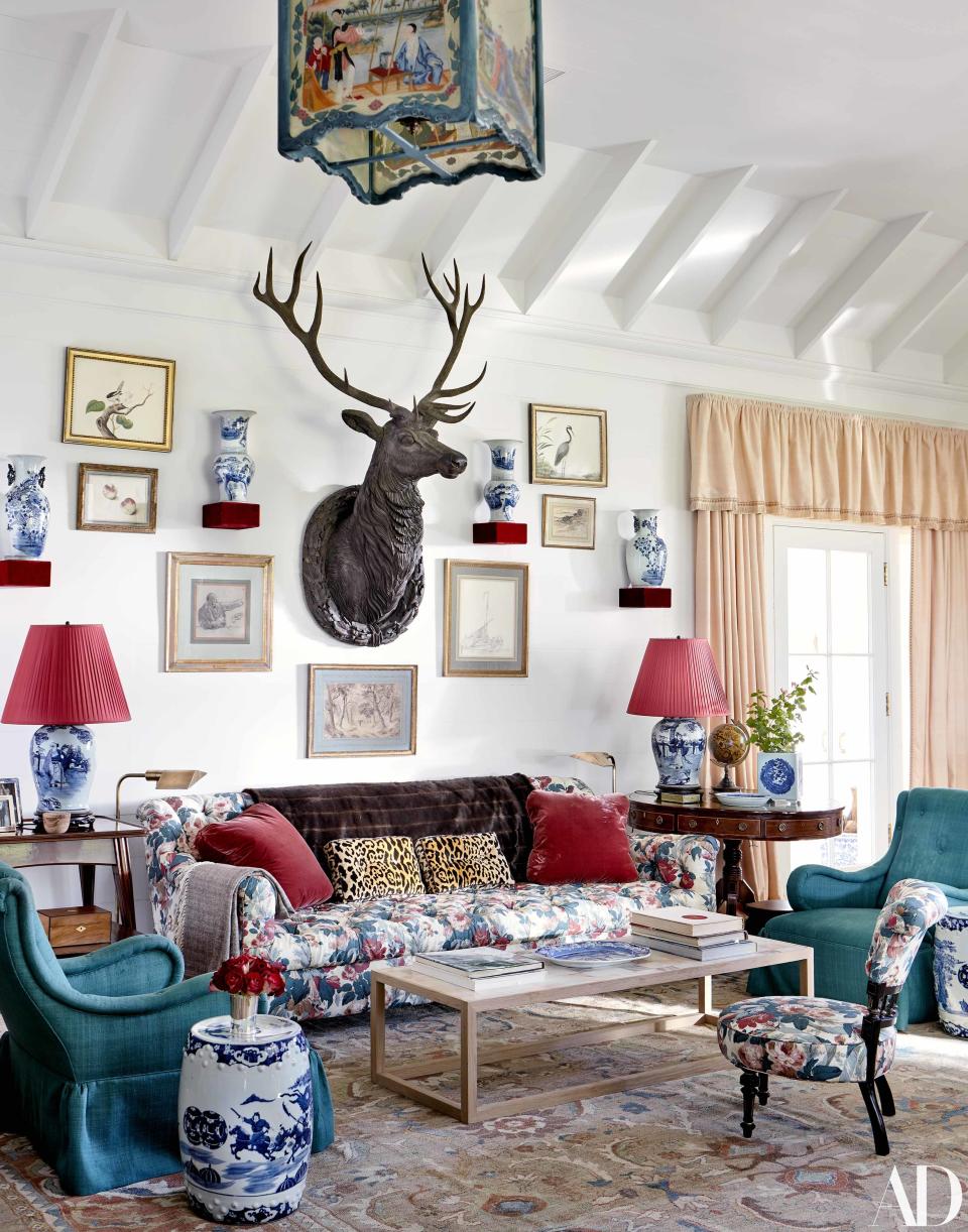 A wood stag trophy watches over the living room. Sofa by Fine Arts Furniture.