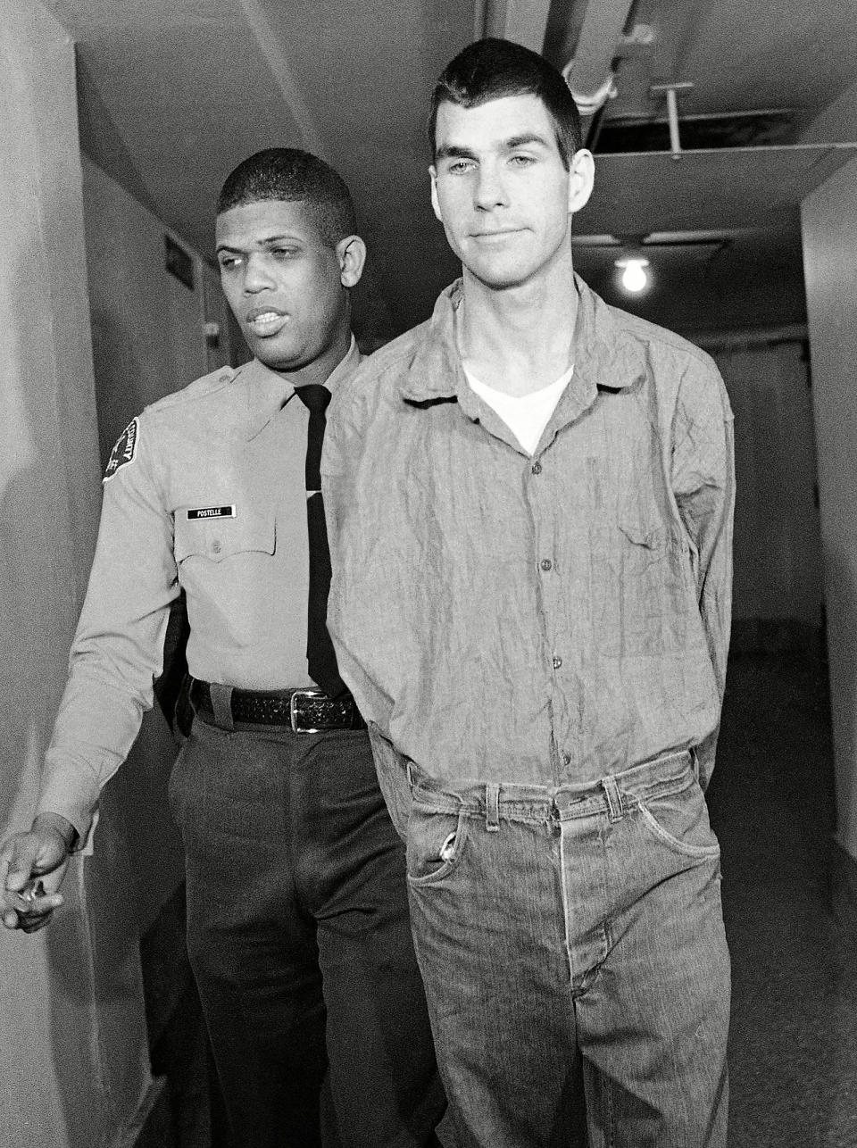 <p>Watson (right), named in court testimony as a killer in the Tate-LaBianca murders, arrives in court for arraignment in L.A. in 1971. Watson, a member of the "Manson family," was ruled insane and unable to stand trial. Doctors later said he had recovered.</p>