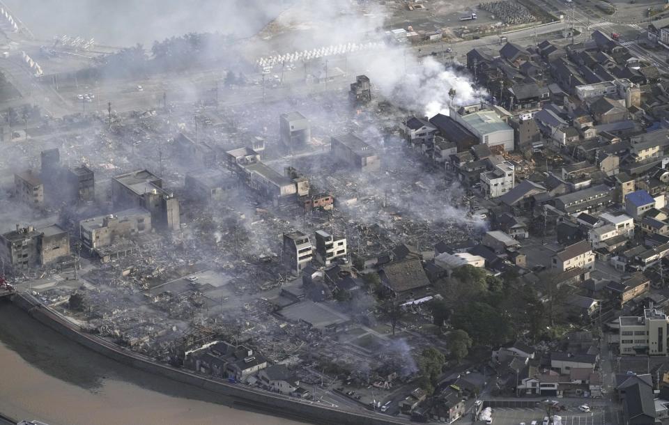 Smoke rises from the site of a fire occurred following an earthquake in Wajima, Ishikawa prefecture, Japan Tuesday, Jan. 2, 2024. (Kyodo News via AP)