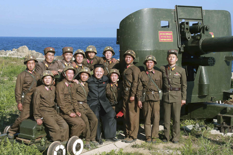 <p>North Korean leader Kim Jong Un poses with soldiers during an inspection of the defense detachment on Ung Islet, which is defending an outpost in the East Sea of Korea, in this undated photo. (KCNA/Reuters) </p>