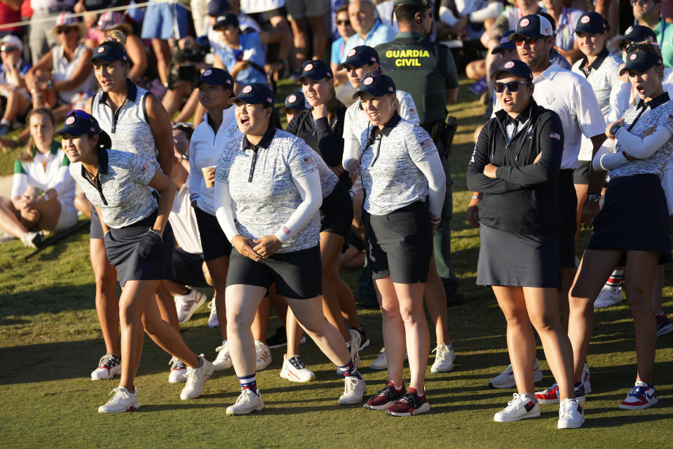 Members of the United States team watch as United States' Angel Yin and playing partner United States' Cheyenne Knight win their afternoon fourball match at the Solheim Cup golf tournament in Finca Cortesin, near Casares, southern Spain, Saturday, Sept. 23, 2023. Europe play the United States in this biannual women's golf tournament, which played alternately in Europe and the United States. (AP Photo/Bernat Armangue)