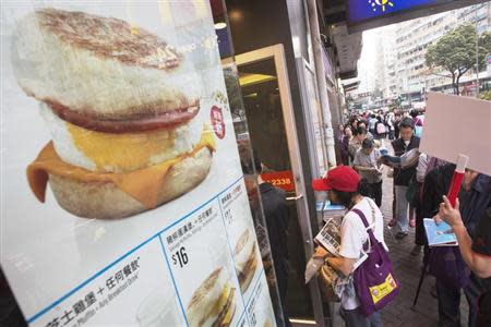 People queue for free offers McMuffin outside a McDonald's outlet at Sham Shui Po, one of the oldest districts in Hong Kong March 18, 2013. REUTERS/Tyrone Siu