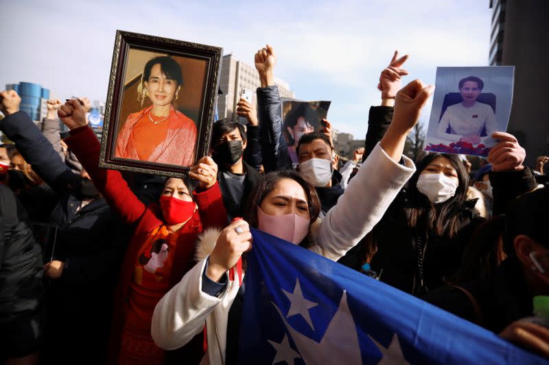 Myanmar protesters residing in Japan hold photos of Aung San Suu Kyi as they rally against Myanmar's military after seizing power from a democratically elected civilian government and arresting its leader Aung San Suu Kyi, in Tokyo