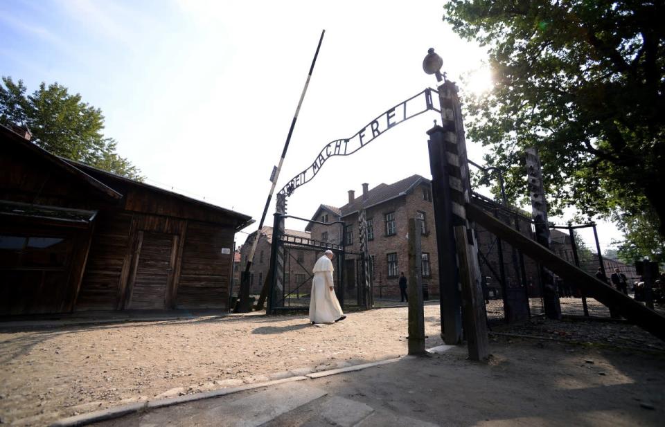 Pope Francis walks through the gate of the former Nazi German death camp of Auschwitz in Oswiecim, Poland, Friday, July 29, 2016.  (Filippo Monteforte/Pool Photo via AP)