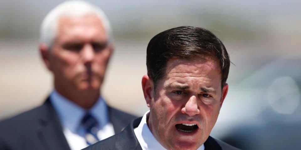 Arizona Gov. Doug Ducey, right, speaks as Vice President Mike Pence, left, watches after the two held a meeting to discuss the surge in coronavirus cases in Arizona Wednesday, July 1, 2020, in Phoenix.