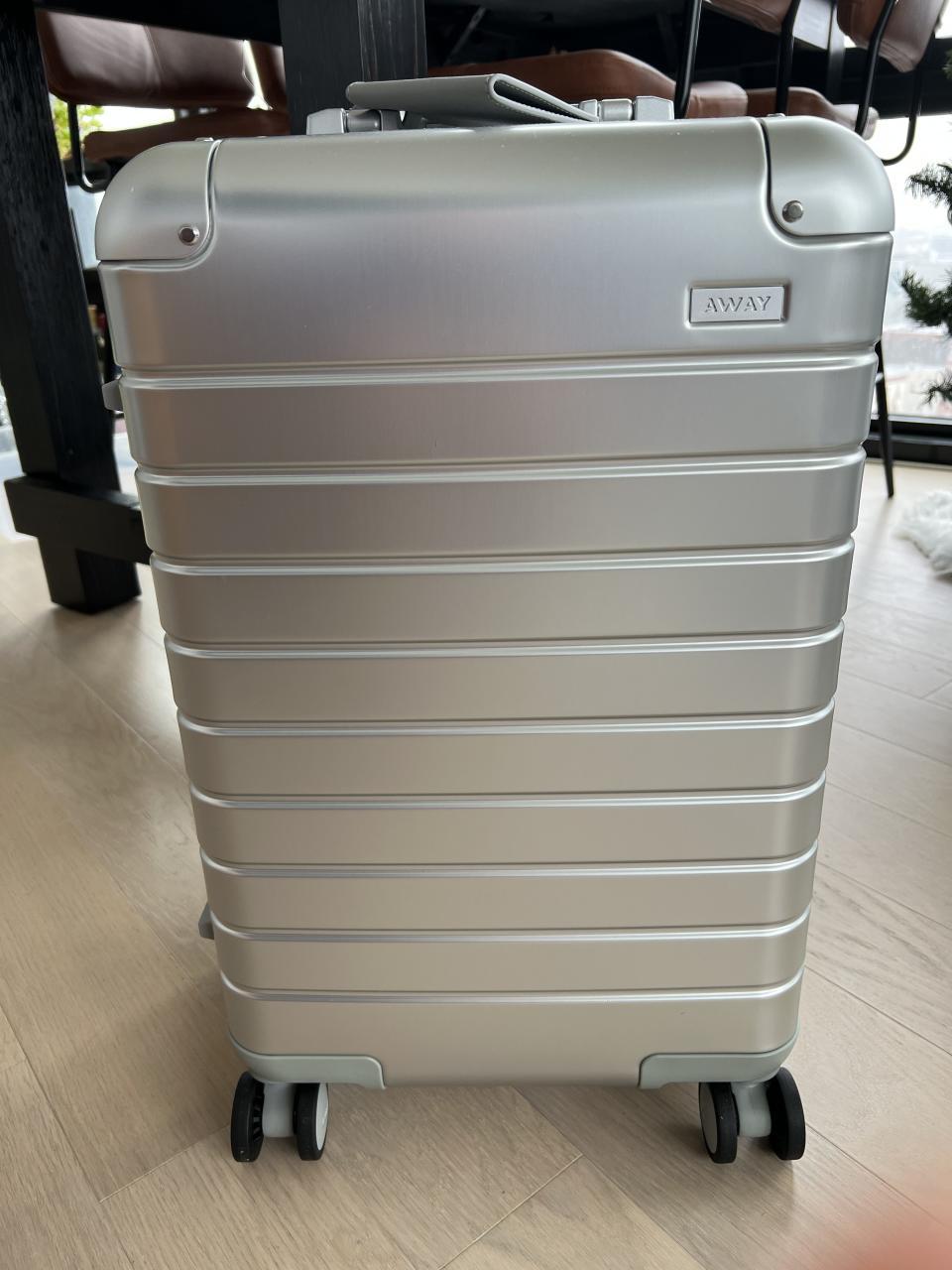 my new away aluminum carry on suitcase sitting in my living room