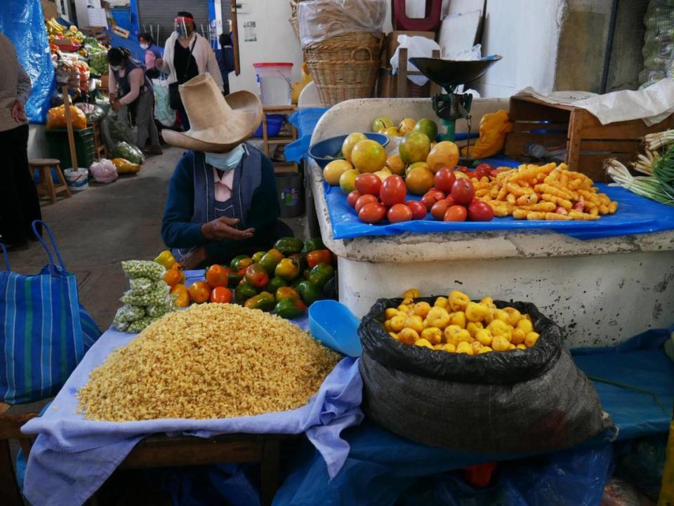 A woman wearing a mask sells produce at a market in Cajamarca, Peru, on May 7, 2021.