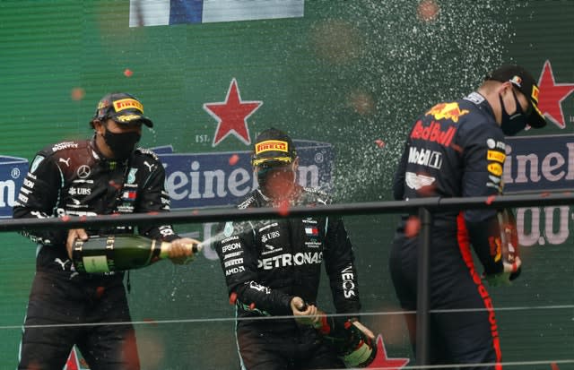 Lewis Hamilton, left, sprays champagne at third-placed Max Verstappen on the podium