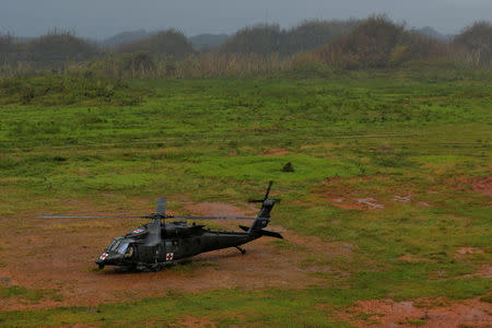 An HH-60 Blackhawk helicopter from 101st Airborne Division's "Dustoff" unit lands in a field to avoid lightning during recovery efforts following Hurricane Maria, in Manati, Puerto Rico, October 5, 2017. REUTERS/Lucas Jackson