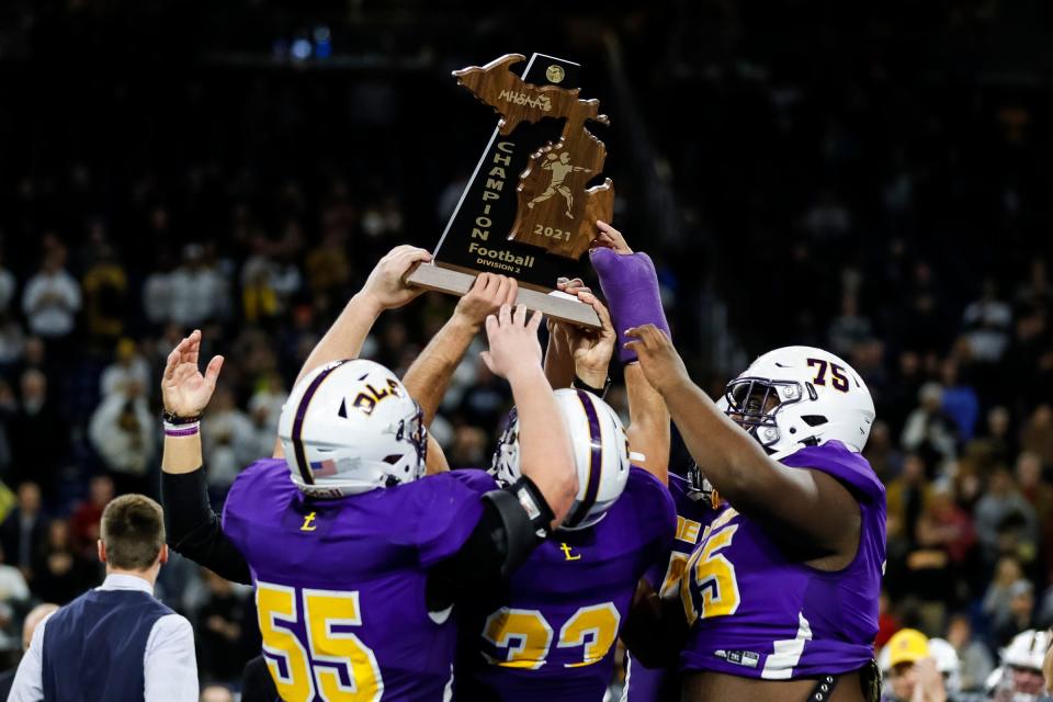 Warren De La Salle celebrates 41-14 win over Traverse City Central at the MHSAA Division 2 football state final at Ford Field in Detroit on Friday, Nov. 26, 2021.